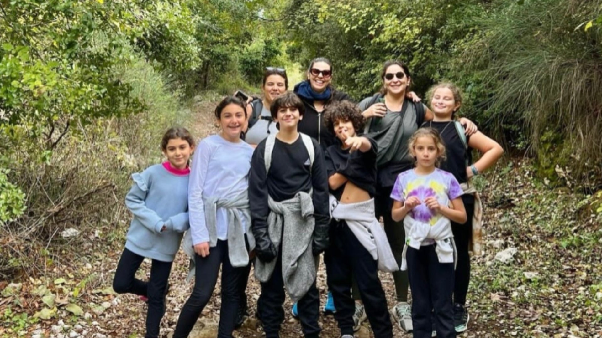 Group of people hiking and posing outdoors in Kfarhelda Lebanon in a natural setting
