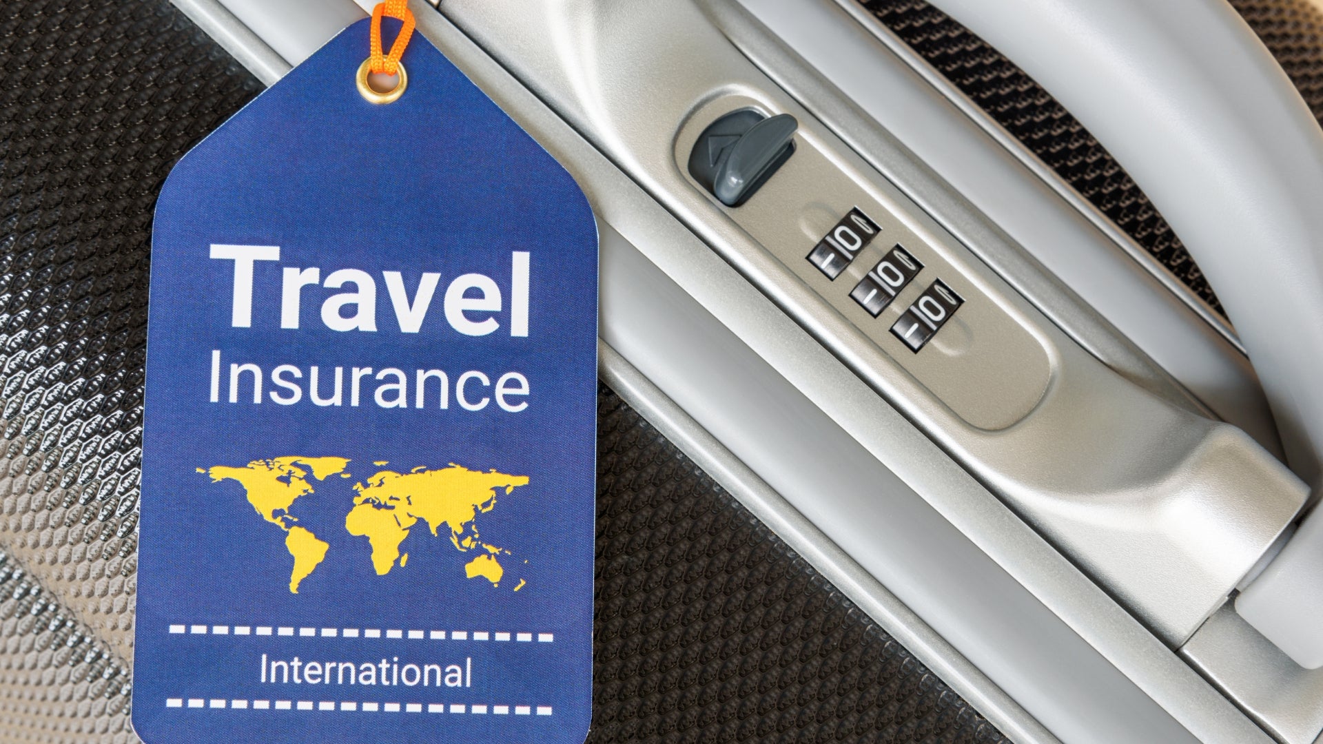 Travel insurance tag attached to a suitcase handle